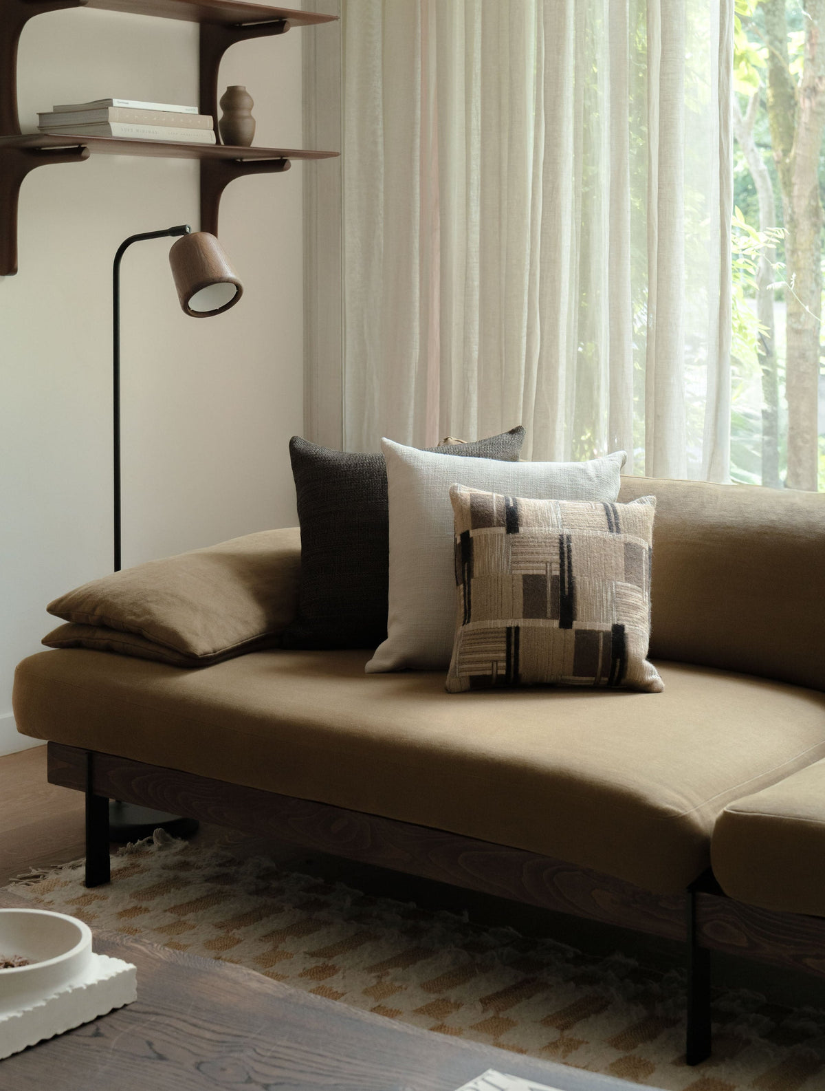 Soft Geometry – Square Trio, featuring three textured cushions in warm neutral tones, styled on a brown sofa