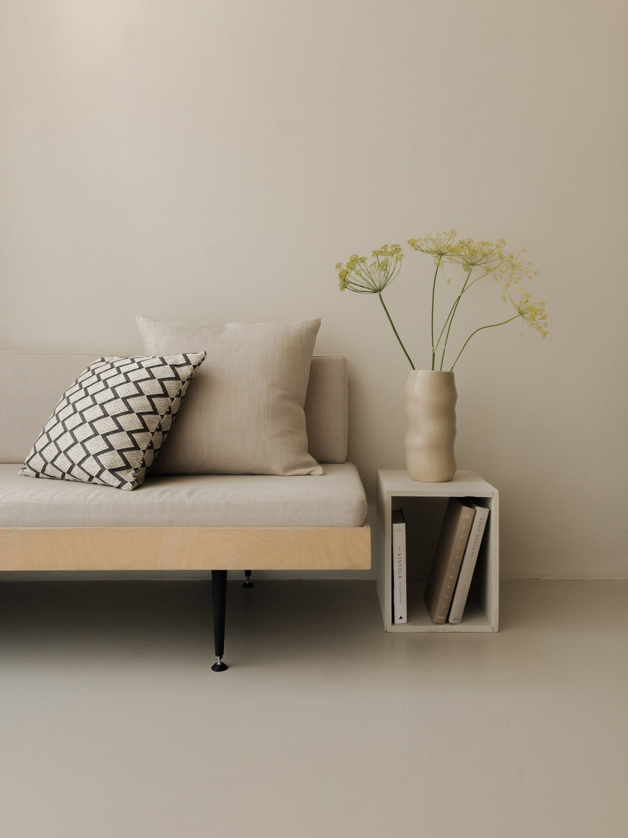 Fine Repeat – Large Pair, featuring two patterned cushions in warm neutral tones, styled on a wood and white sofa