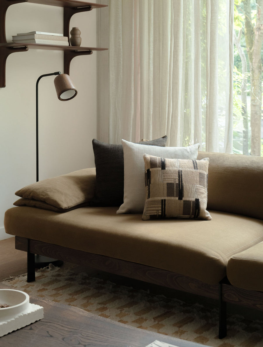 Soft Geometry – Square Trio, featuring three textured cushions in warm neutral tones, styled on a brown sofa