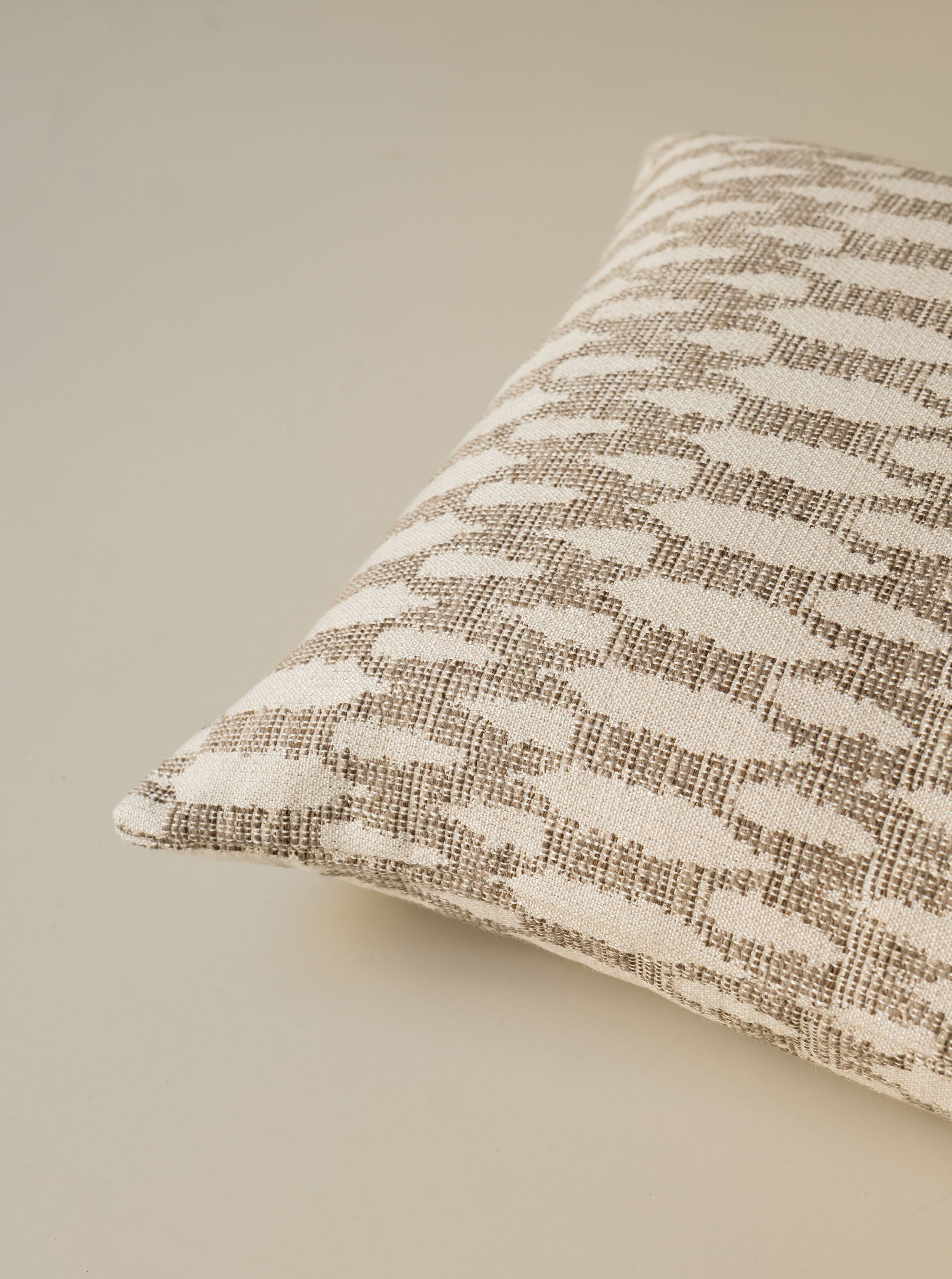 Close-up of the corner of the Birch – Fawn cushion, highlighting the textured fabric and refined finish