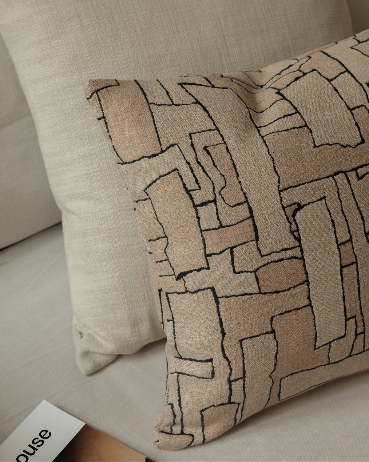 Close-up of the Faded Forms – Large Pair, highlighting the cushions’ soft neutral tones and contrasting woven textures
