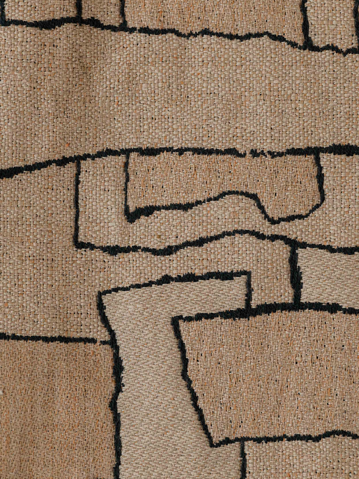 Close-up of the Naoki – Rose des Sables fabric, showing its abstract geometric pattern and textured woven surface