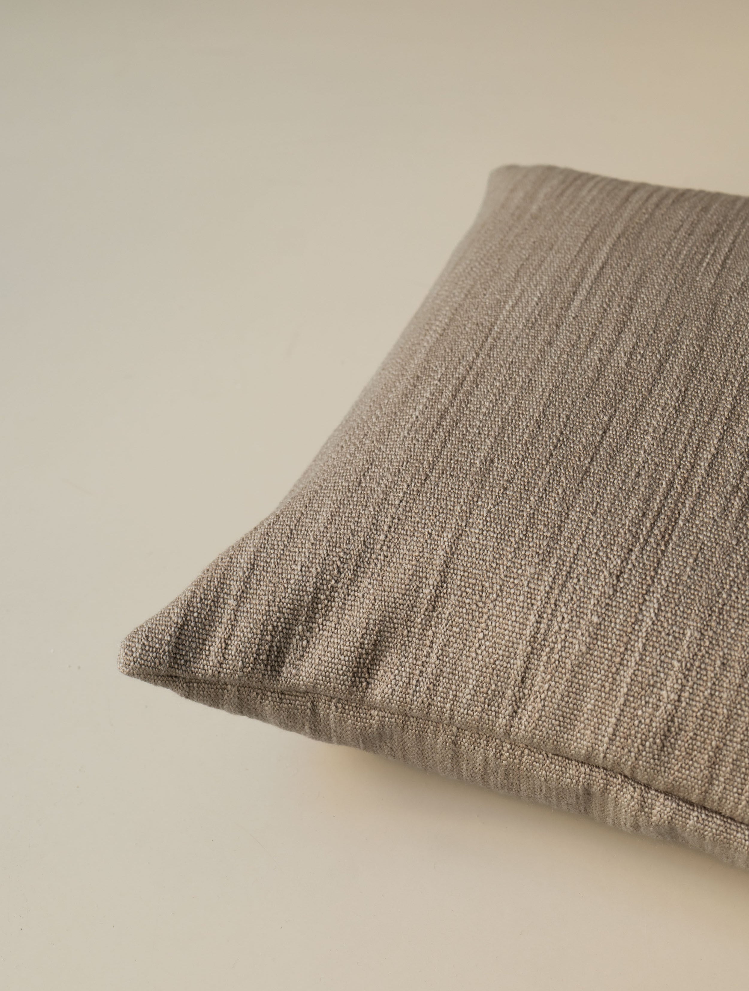 Close-up of the corner of the Scotland – Chamois cushion, highlighting the textured woven fabric and neatly finished seams
