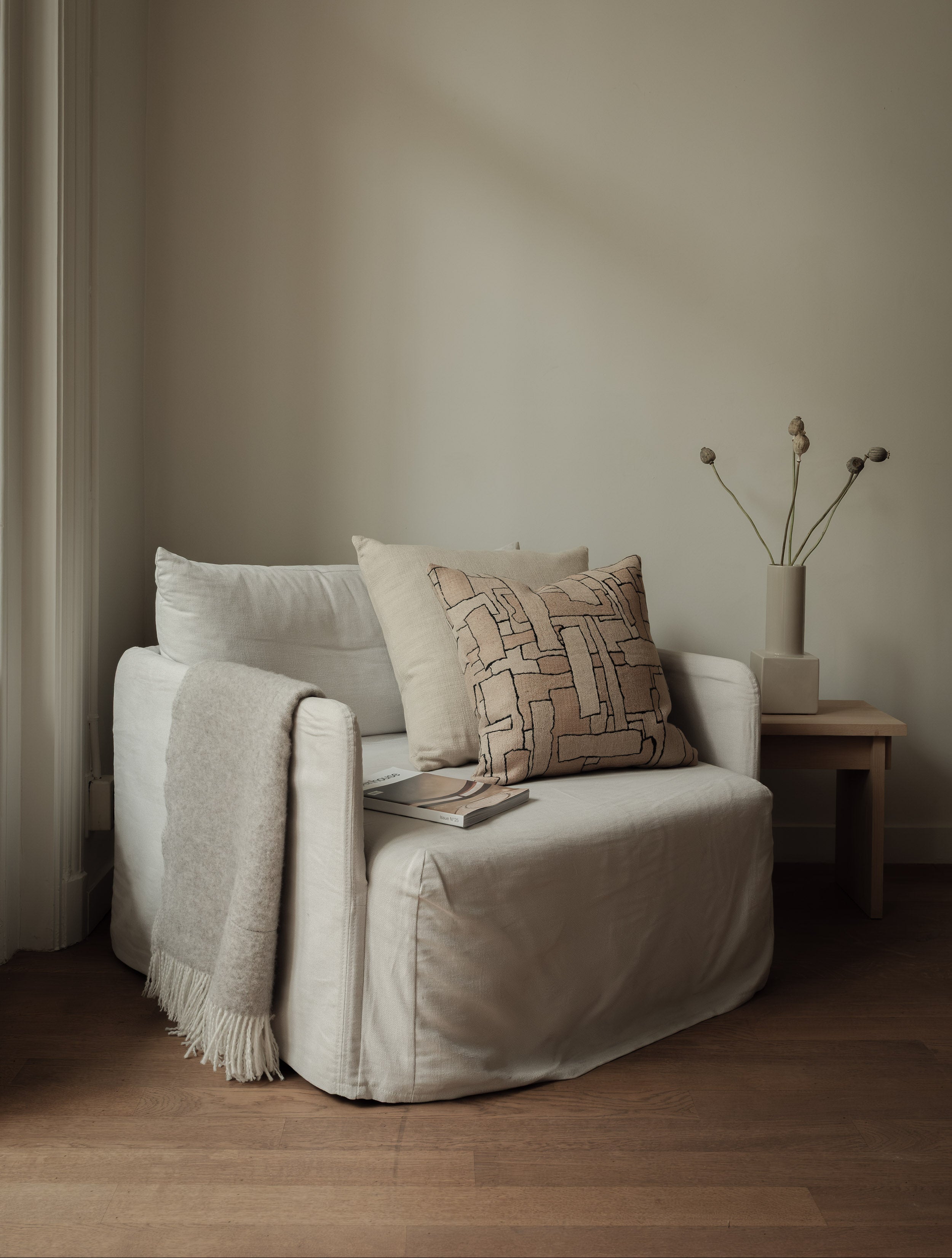 Faded Forms – Large Pair, featuring two textured cushions in soft neutral tones, styled on a white armchair
