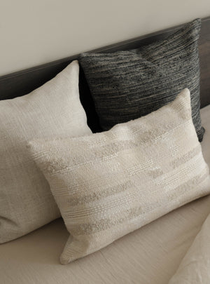 Close-up of the Hints of Blue – Roquebrune trio, showing the cushions’ woven textures and muted blue-grey, brown and natural tones